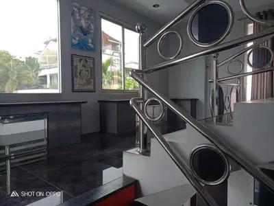 a staircase in a room with a fireplace andwindows at Villa Rawai Pool 3 Room in Ban Saiyuan (1)