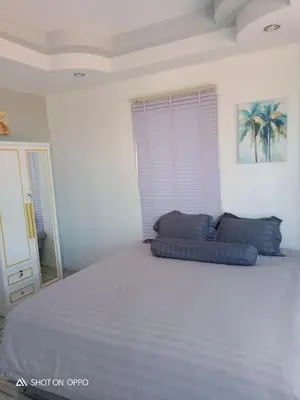 a bedroom with a large bed with two pillows on it at Villa Rawai Pool 3 Room in Ban Saiyuan (1)
