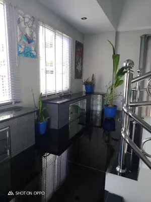 a kitchen with black counter tops and potted plants at Villa Rawai Pool 3 Room in Ban Saiyuan (1)