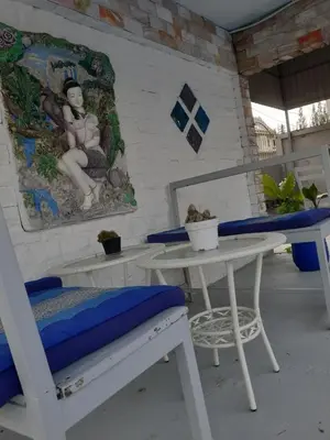 a room with a table and a chair and a table and a bench at Villa Rawai Pool 3 Room in Ban Saiyuan (1)