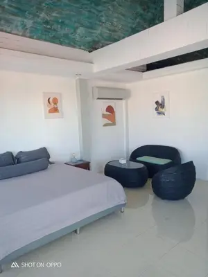 a bedroom with two ottomans and two chairs at Villa Rawai Pool 3 Room in Ban Saiyuan (1)