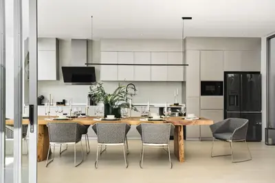 a kitchen with a large wooden table and chairs at Trinity 4 BDR POOL Villa in Ban Pak Lak