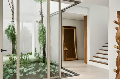a house with an aquarium in the middle of a hallway at Trinity 4 BDR POOL Villa in Ban Pak Lak