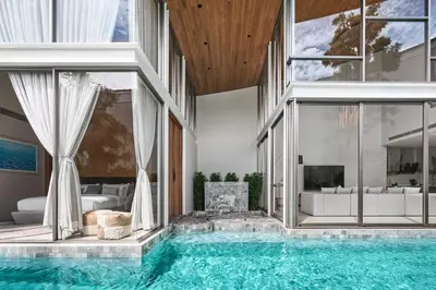 an indoor swimming pool in a house at Trinity 4 BDR POOL Villa in Ban Pak Lak