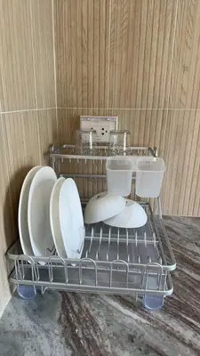 a plate rack with plates and dishes on it at House No 21-77 Near bangtao beach Phuket in Koh Lone