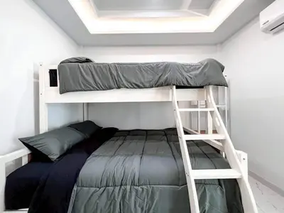 a bunk bed in a room with a ladder at Modern House in Phuket Town in Ban Na Khua