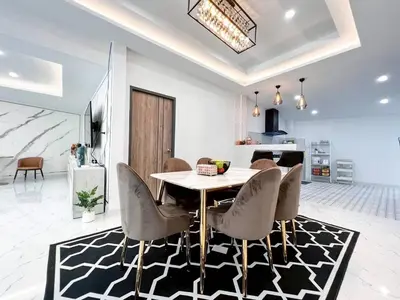a dining room with a table and chairs at Modern House in Phuket Town in Ban Na Khua
