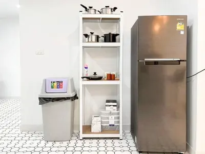 a kitchen with a stainless steel refrigerator in a room at Modern House in Phuket Town in Ban Na Khua