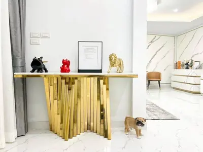 a table with figurines of cats and a dog at Modern House in Phuket Town in Ban Na Khua