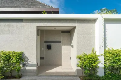 a white building with a door in front of it at MONO Villa Bang Tao 3 bedroom modern pool villa in Ban Pak Lak