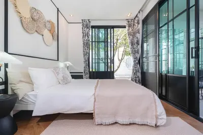 a bedroom with a large bed and glass doors at MONO Villa Bang Tao 3 bedroom modern pool villa in Ban Pak Lak