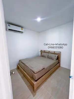 a bedroom with a bed in a white room at Tim House Thalang 3 in Ban Phak Chit