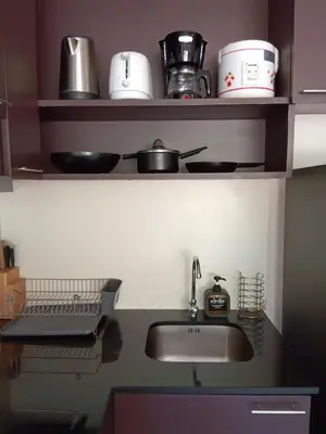 a kitchen counter with a sink and pots and pans at A Big Condo in Karon Walking distance to Beach in Karon Beach