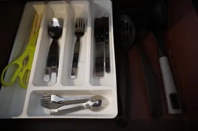 a plastic tray with forks and spoons and utensils at A Big Condo in Karon Walking distance to Beach in Karon Beach