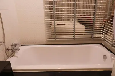 a white bath tub in a bathroom with a window at A Big Condo in Karon Walking distance to Beach in Karon Beach