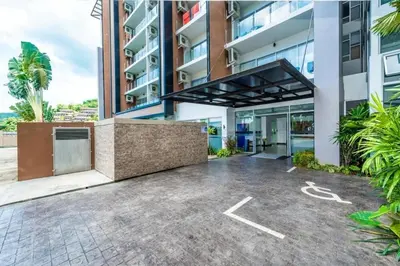 an empty parking lot in front of a building at A Big Condo in Karon Walking distance to Beach in Karon Beach