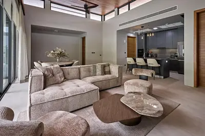 a living room with a couch and a table at Villa Botanica Modern Loft 2 in Ban Tha Rua