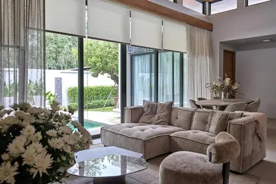 a living room with a couch and a table at Villa Botanica Modern Loft 2 in Ban Tha Rua