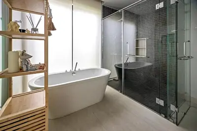 a bathroom with a tub and a glass shower at Villa Botanica Modern Loft 2 in Ban Tha Rua