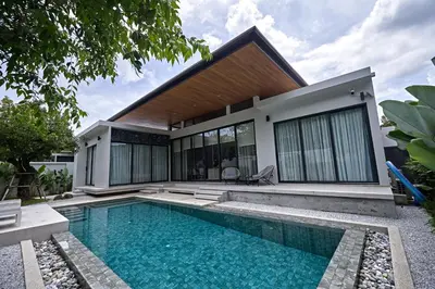 a house with a swimming pool in front of it at Villa Botanica Modern Loft 2 in Ban Tha Rua