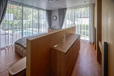 a bedroom with a bed and large windows and a desk at Villa Botanica Modern Loft 2 in Ban Tha Rua