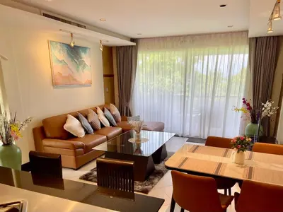 a living room with a couch and a table at Kata Eden View - 1 BR Beachfront Luxury Apartment in Karon Beach