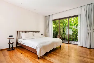 a bedroom with a bed and a large window at Qabalah by Villacarte in Ban Pak Lak