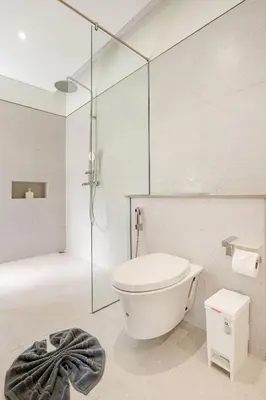 a bathroom with a shower and a toilet and a tub at Qabalah by Villacarte in Ban Pak Lak