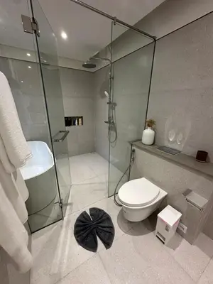 a bathroom with a glass shower and a toilet at Qabalah by Villacarte in Ban Pak Lak