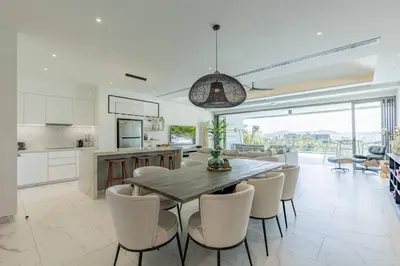 a kitchen and dining room with a table and chairs at Beautiful Andamaya sea view in Ban Thalat Choeng Thale