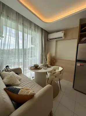 a living room with a couch and a table at Fantasea Condo Kamala in Kamala Beach