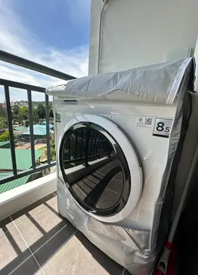 a washing machine sitting on top of a balcony at Fantasea Condo Kamala in Kamala Beach