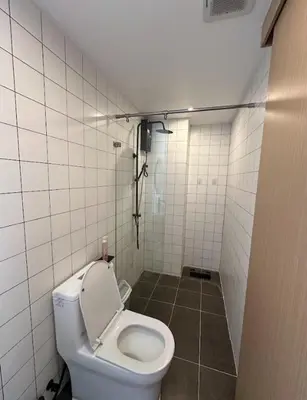 a bathroom with a toilet in a tiled room at Fantasea Condo Kamala in Kamala Beach