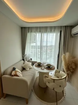a living room with a couch and a table at Fantasea Condo Kamala in Kamala Beach