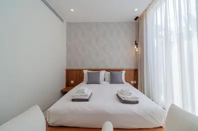 a bedroom with a white bed with towels on it at 3bdr New Luxury Villa Bang Tao by CapitalPro ASH-06 in Ban Phru Champa