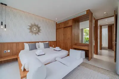 a bedroom with a large white bed and a window at 3bdr New Luxury Villa Bang Tao by CapitalPro ASH-06 in Ban Phru Champa