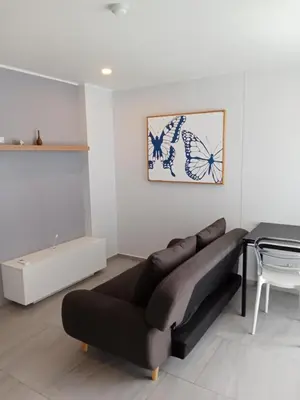 a living room with a couch and a table at Stylish Urban Escape 1Bed Apt T2-822 in Chalong