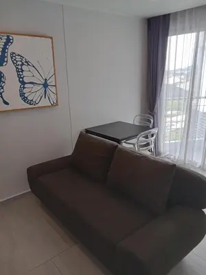 a living room with a couch and a table at Stylish Urban Escape 1Bed Apt T2-822 in Chalong