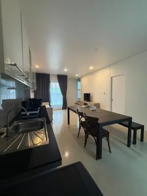 a kitchen and living room with a table and chairs at Town House European Style in Ban Ket Ho