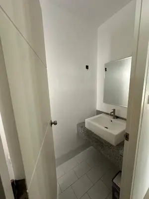 a white bathroom with a sink and a mirror at Town House European Style in Ban Ket Ho