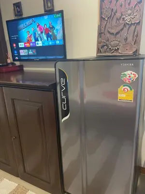 a refrigerator with a tv on top of it at The Buddha Rawai Villa in Ban Saiyuan (1)