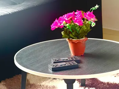 a table with a pot of flowers on top of it at Patong Canal Villa 302 in Patong Beach