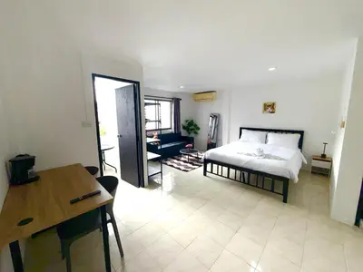a bedroom with a bed and a desk in a room at Patong Canal Villa 302 in Patong Beach