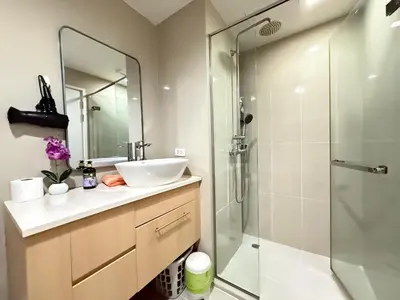 a bathroom with a sink and a shower at The Deck Patong Phuket by Mickey in Patong Beach