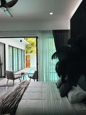 a bedroom with a large bed and a patio at Exclusive 2BR Pool Villa in Ban Saiyuan (1)