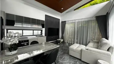 a living room with a couch and a table at Exclusive 2BR Pool Villa in Ban Saiyuan (1)