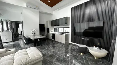 a living room with a couch and a large tv at Exclusive 2BR Pool Villa in Ban Saiyuan (1)