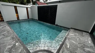 a swimming pool on the side of a building at Exclusive 2BR Pool Villa in Ban Saiyuan (1)