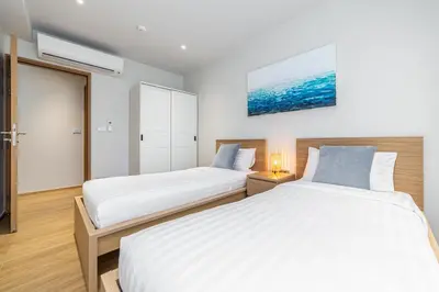 a bedroom with two beds and a tv at Beachside 2 bedrooms apartment 200 meters to Bang Tao Beach Manage by OCEAN HUB in Bang Tao Beach