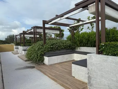 a group of benches with plants on a patio at Beachside 2 bedrooms apartment 200 meters to Bang Tao Beach Manage by OCEAN HUB in Bang Tao Beach